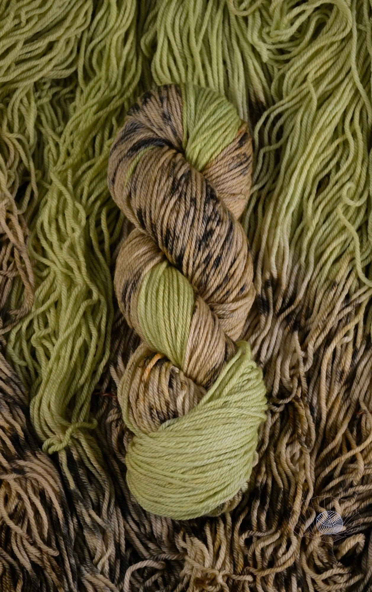 A self striping yarn with pistachio and tan with brown spots. Dyed on a worsted weight yarn.