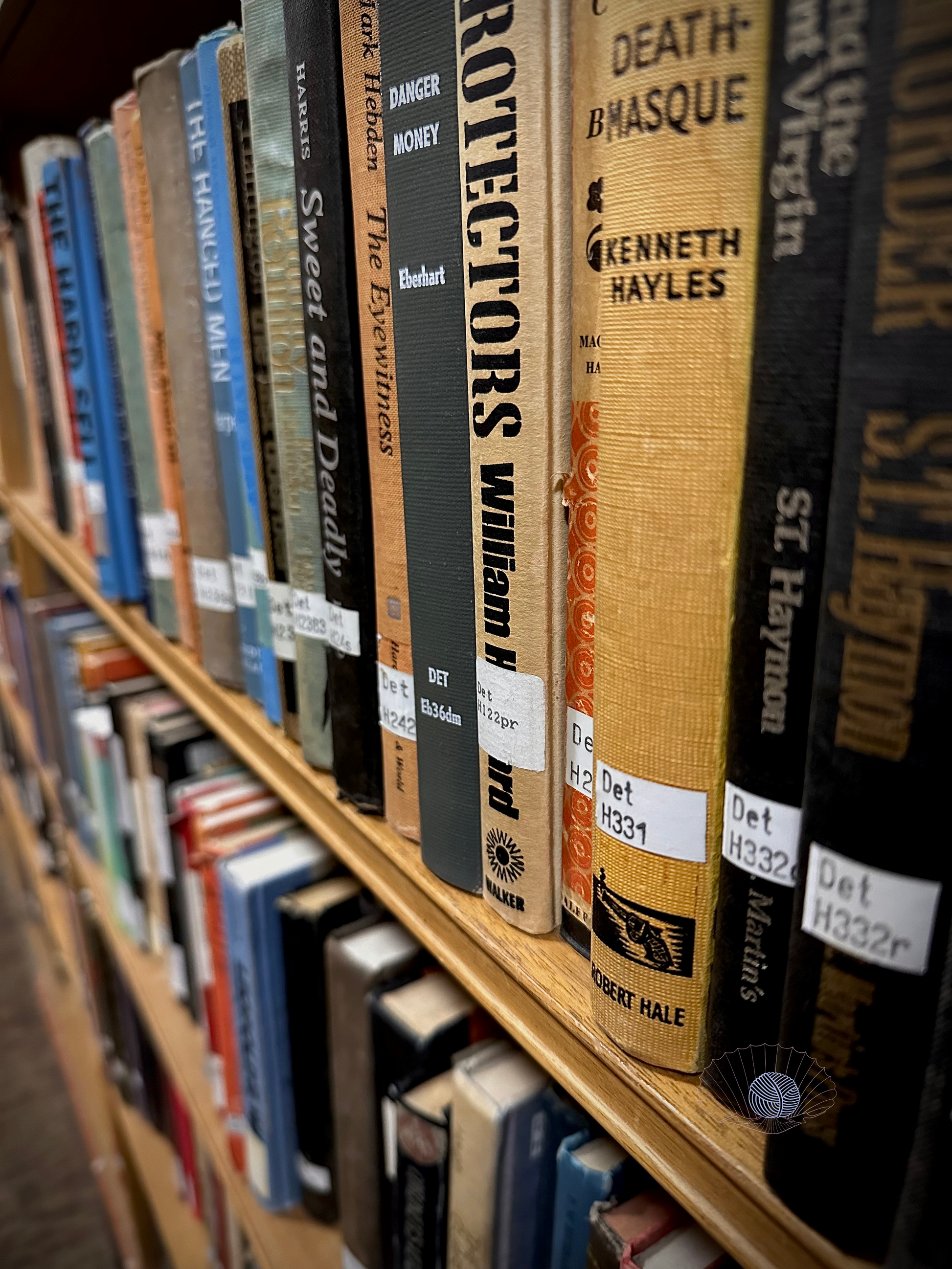 Closeup of hardcover books in a wooden bookcase