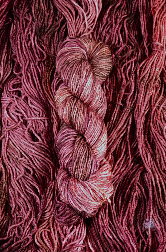 A tonal yarn of burgundy, crimson, and pink. Dyed on worsted weight yarn.
